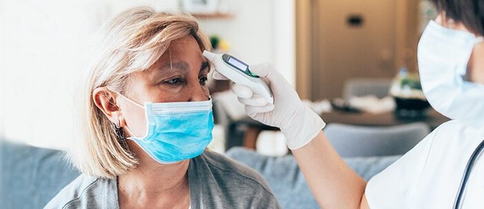 Woman getting her temperature taken image